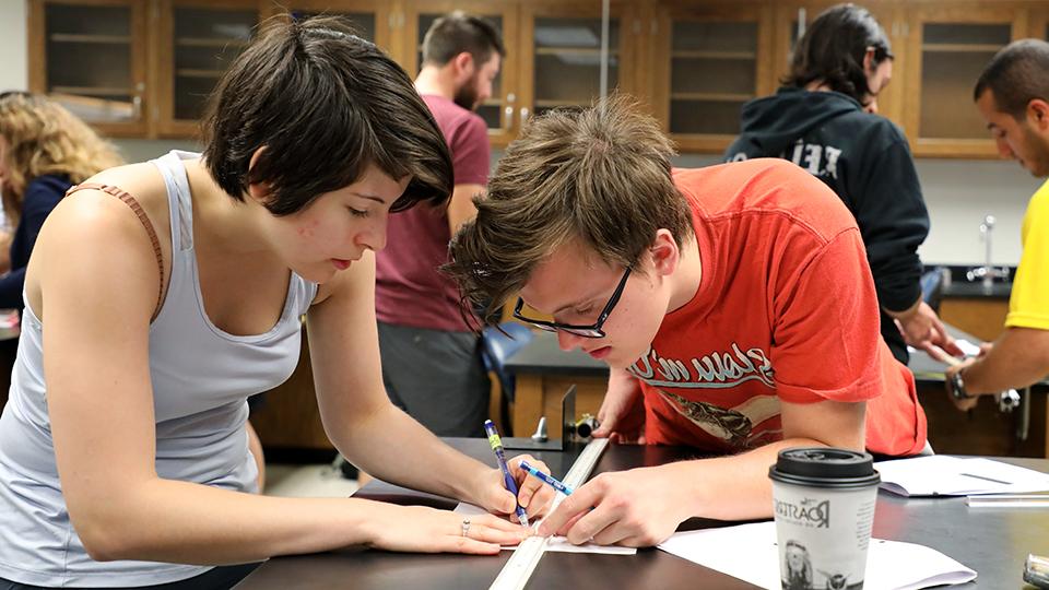 Two students working on an engineering project