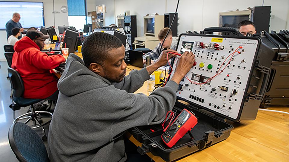 Student working on a circuit board